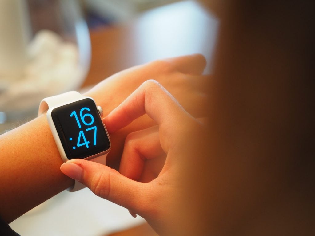 Woman checking time on digital watch