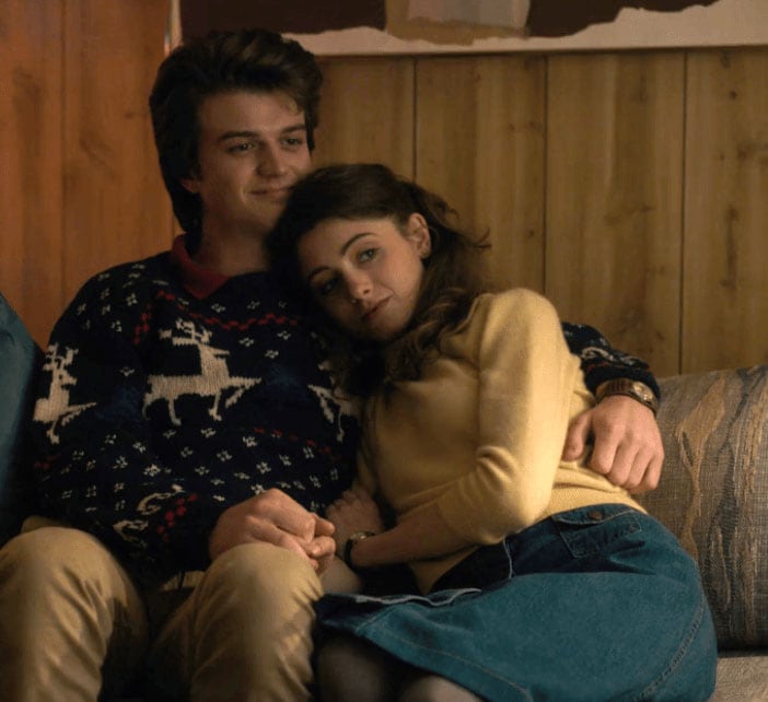 Nancy Wheeler and Steve Harrington on the couch in Stranger Things