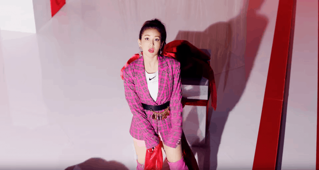 Somi style in the Birthday music video - Jeon Somi wearing plaid blazer, pink over the knee boots, nike tee, belt