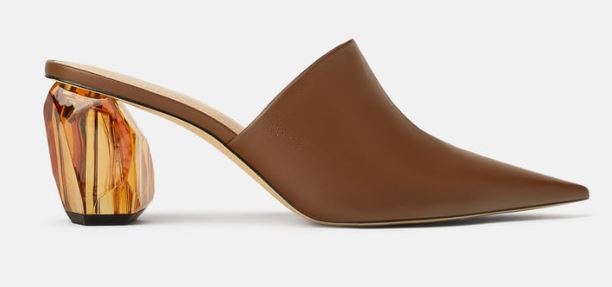 A brown leather mule with a round geometric heel