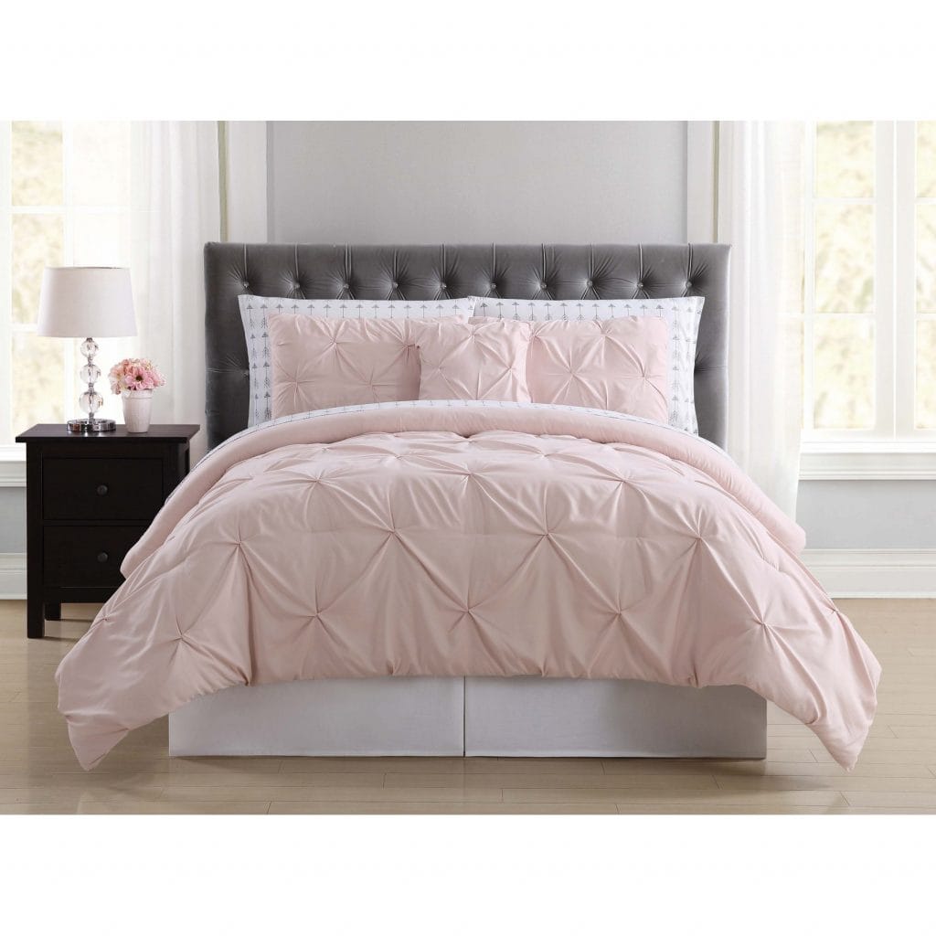Where to buy dorm bedding: Pink ruffle bedding with gray headboard and black nightstand 