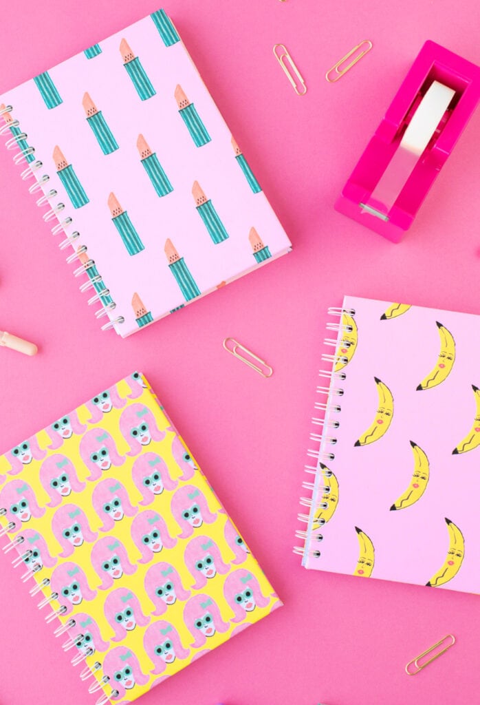 patterned notebooks on pink background