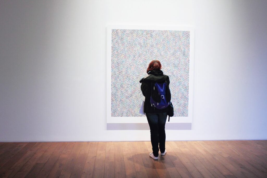 A student studies a painting.