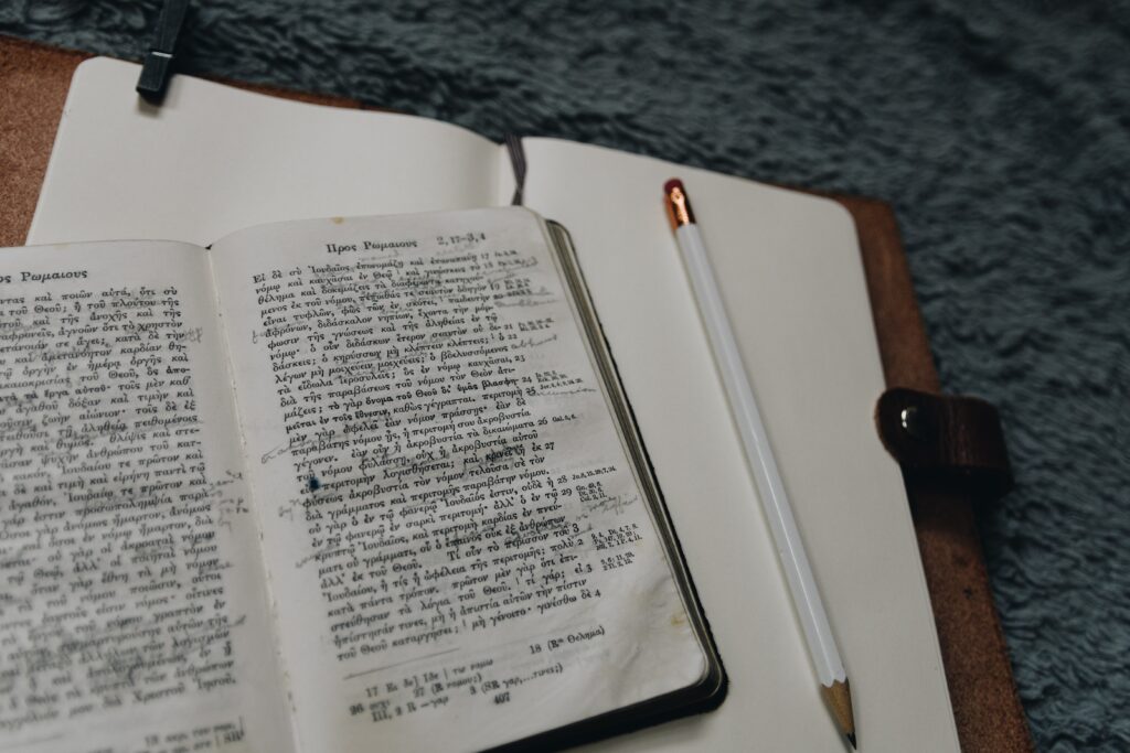 Cheap textbooks guide - pencil next to open book with writing inside