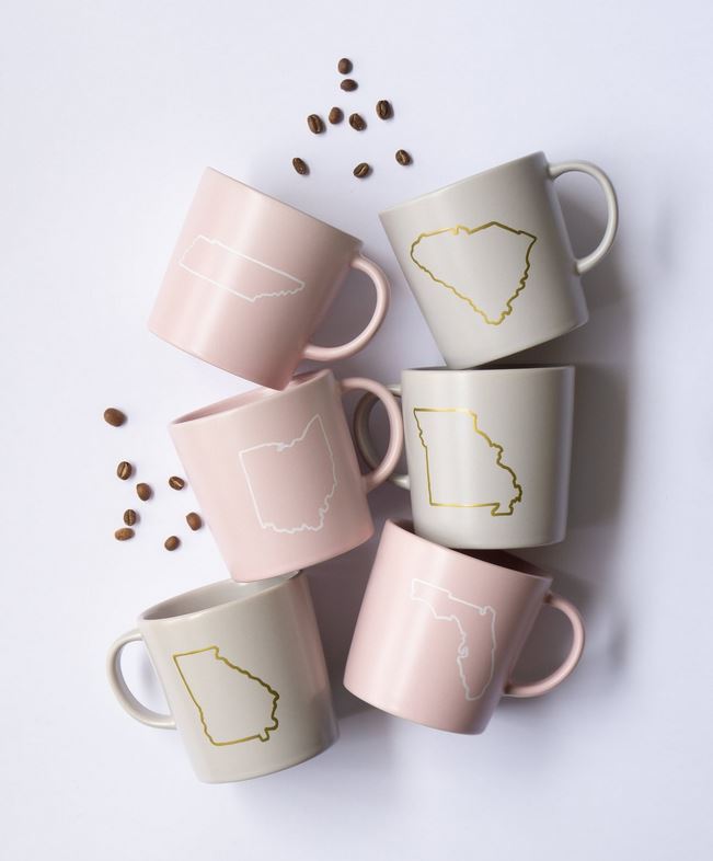 Pastel pink + grey state mugs.