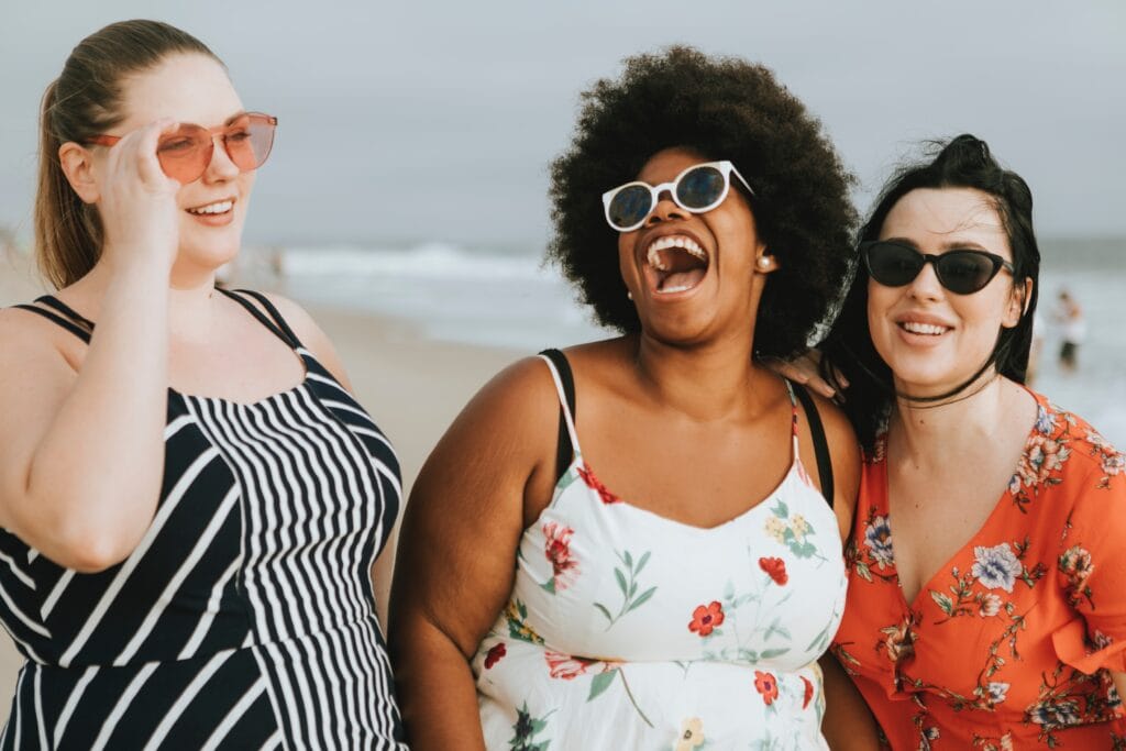 How to travel in college - pic of Friends laughing at the beach.