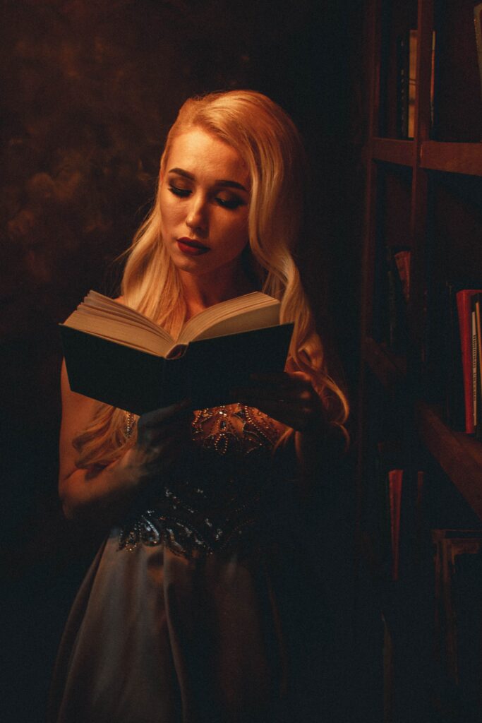 Things to do for Halloween - read horror fiction, photo of a girl reading book in orange room - halloween costumes