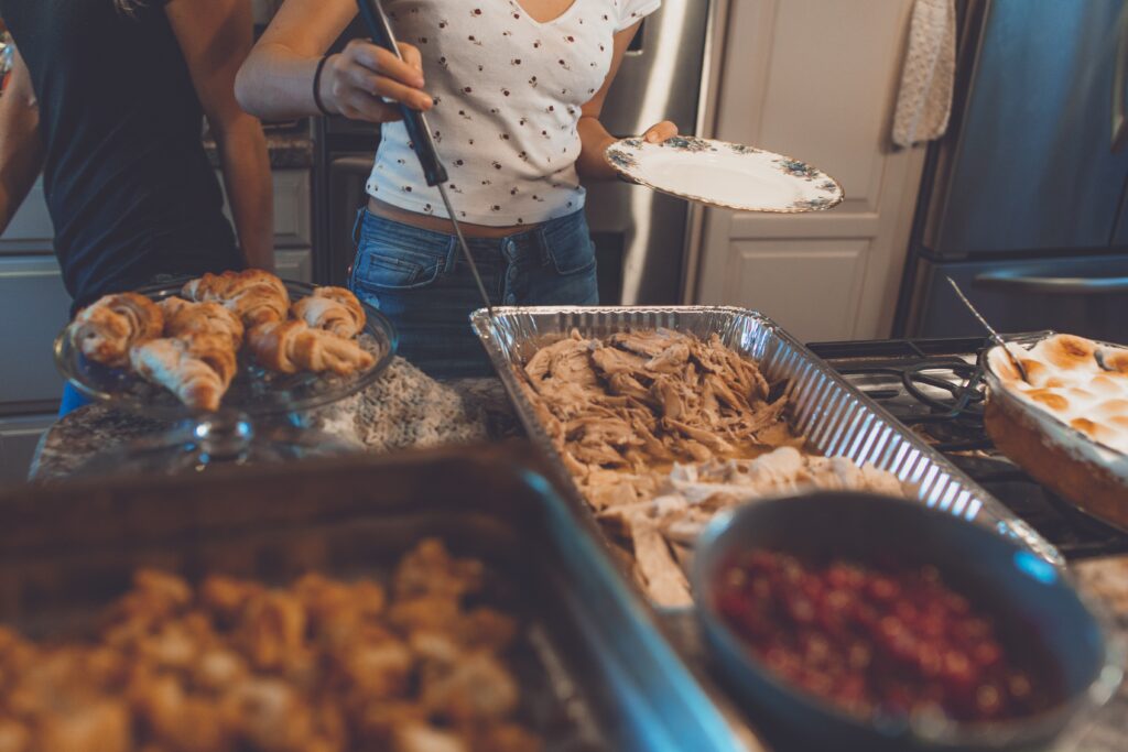 Girl taking food from a table.