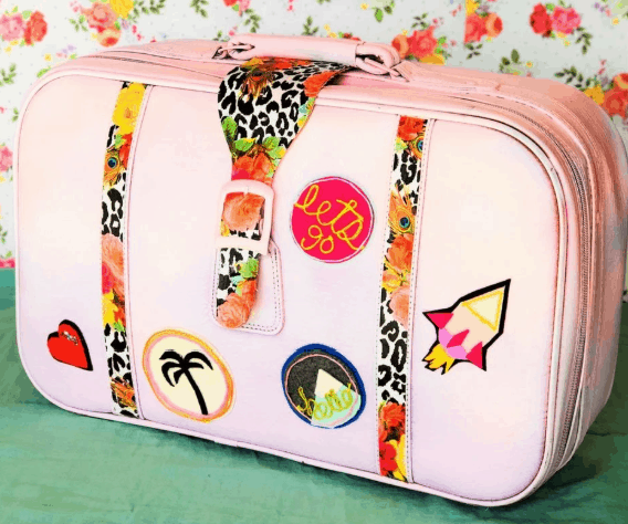 pink suitcase with patches and fabric