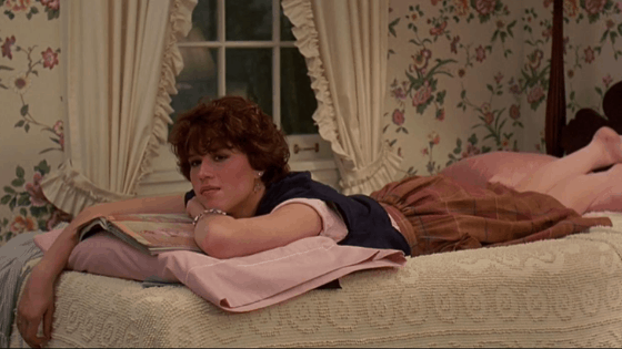 Sixteen Candles fashion: Samantha wearing pink skirt, black vest, cropped t-shirt