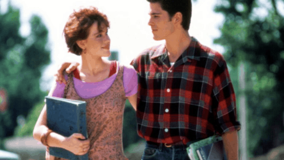 Sixteen Candles fashion - Samantha wearing a leopard dress, purple t-shirt, and red tank top while walking with Jake Ryan