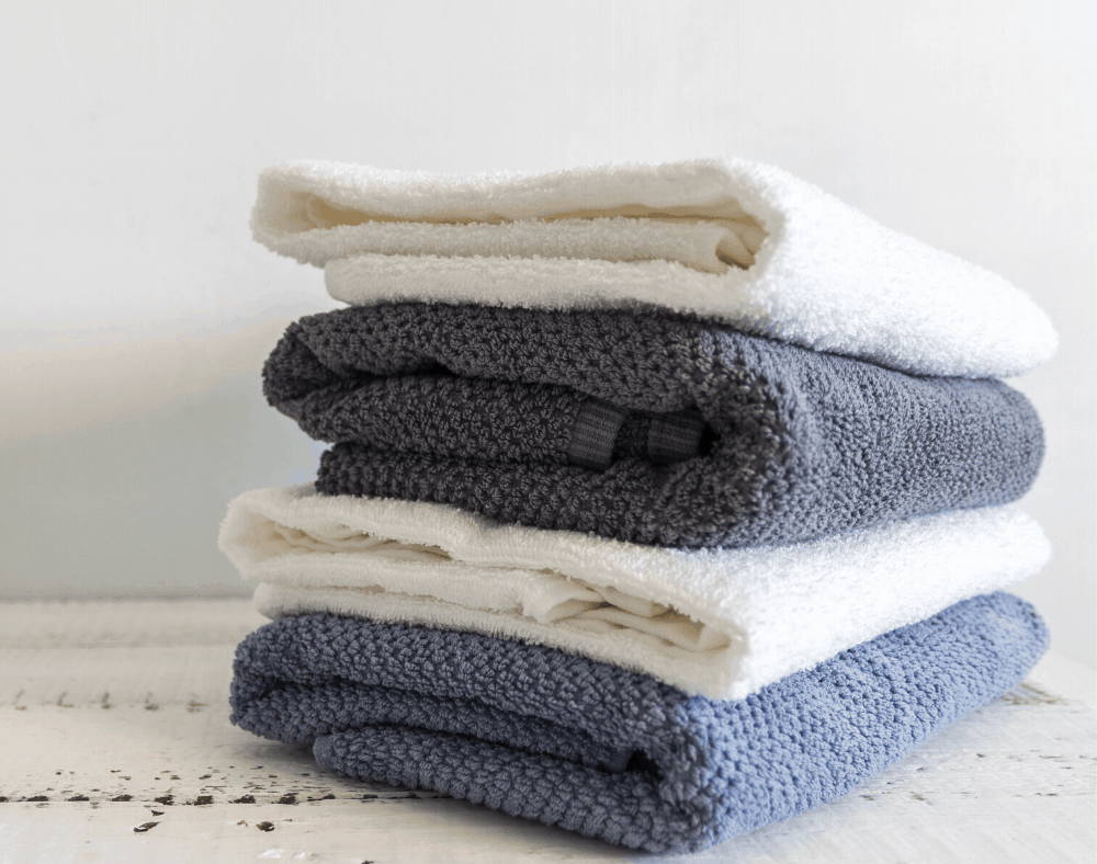 How to keep clothes looking new - pile of sweaters