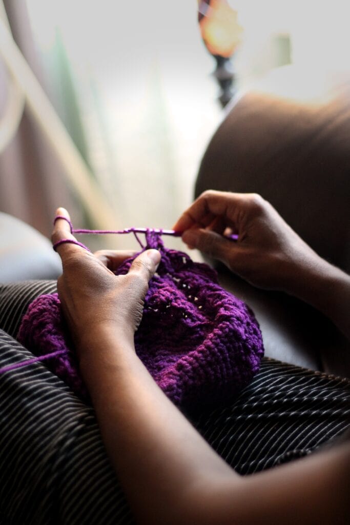 crocheting with purple yarn