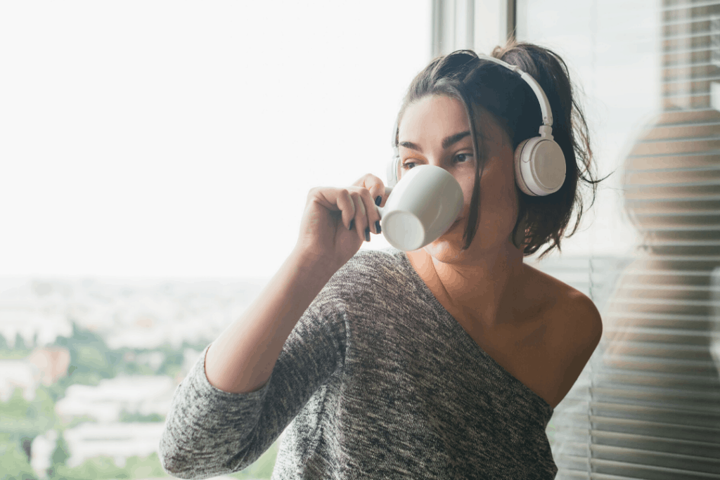 New Years resolutions for students: Photo of a student with a cup of coffee and headphones