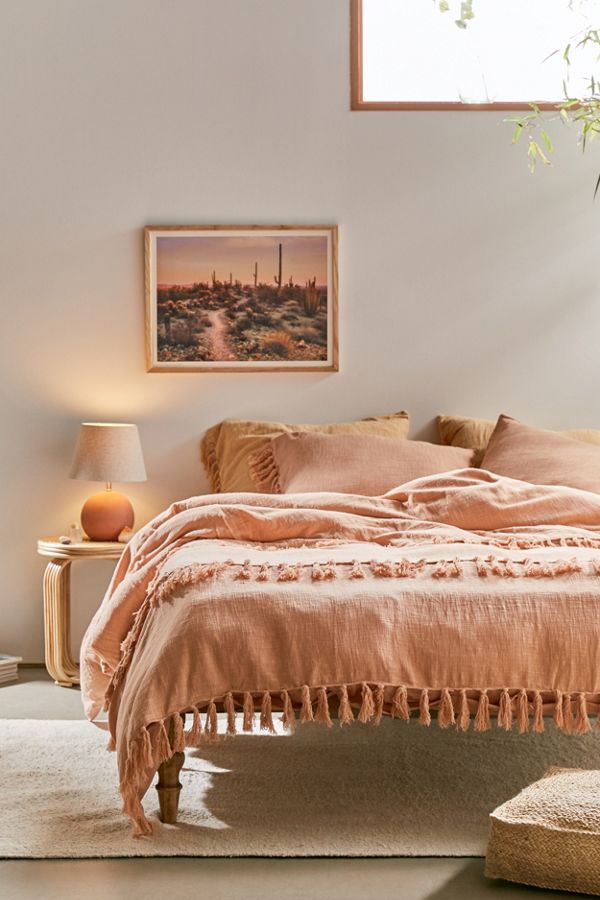 Urban Outfitters salmon comforter with fringe.