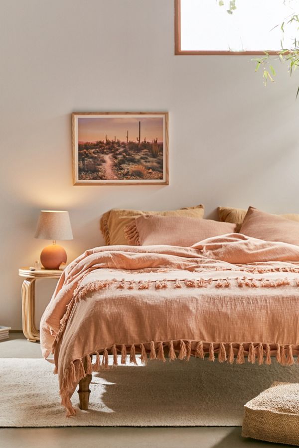 Urban Outfitters salmon comforter with fringe.