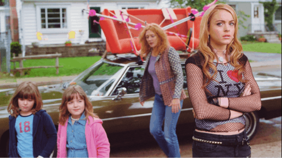 Confessions of a Teenage Drama Queen style: Photo of Lola, played by Lindsay Lohan, wearing an I Love New York t-shirt, a mesh overlay, and black low rise jeans