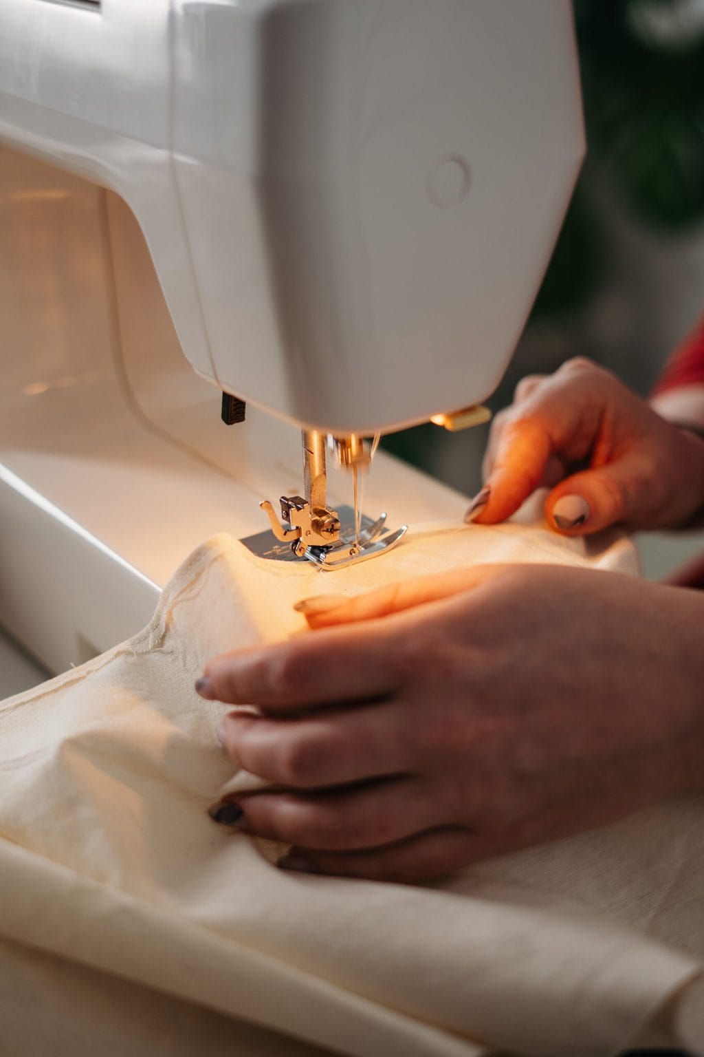 Fashion tips for big busts - get things tailored. Stock photo of sewing with a machine