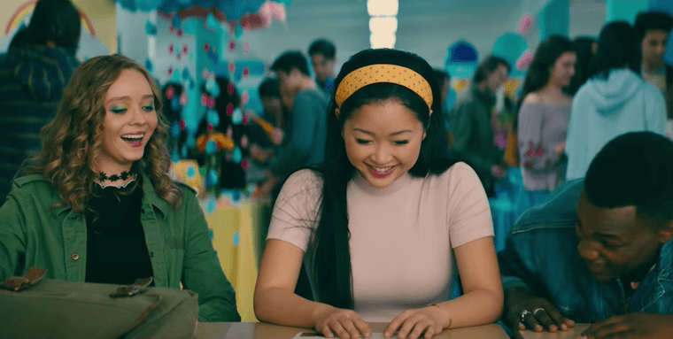 Lara Jean Covey in To All the Boys P.S. I Still Love You, wearing a pink t-shirt and yellow polka dot headband