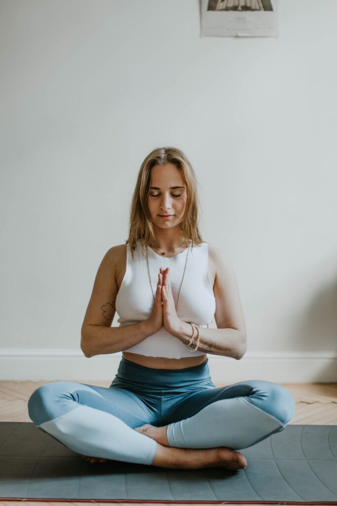 Ways to destress - woman doing yoga inside a room