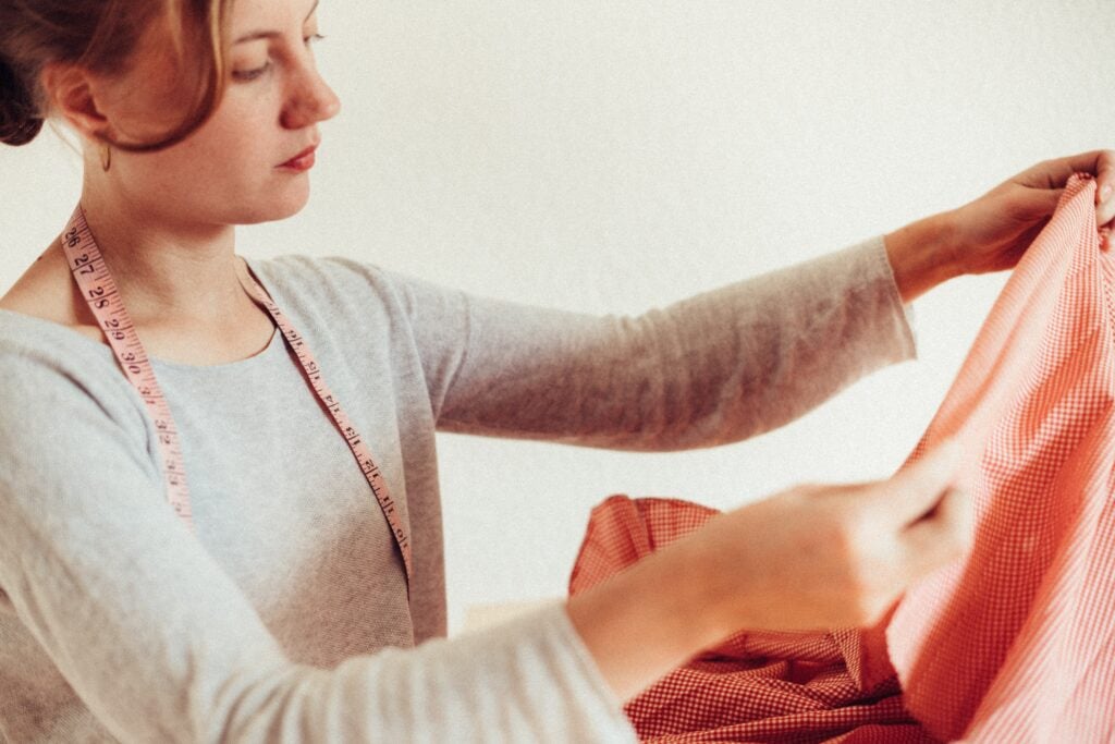 Stock photo of a woman holding fabric