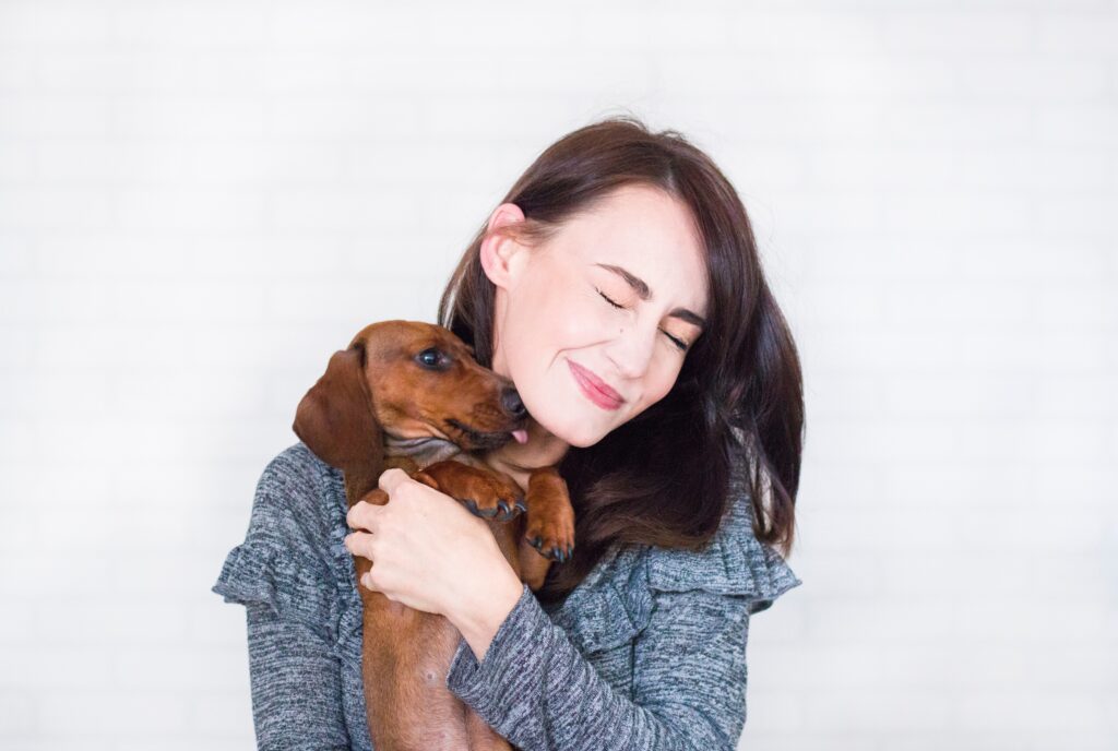 Woman holding dog.