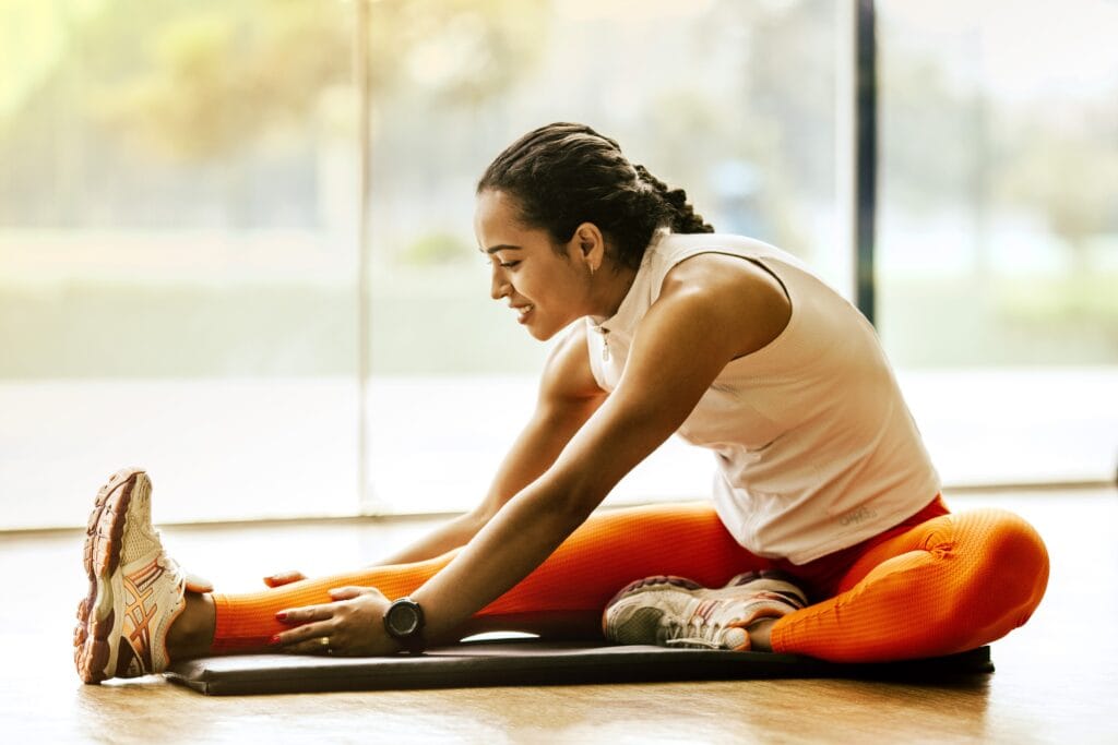 Ways to destress - Woman stretching on ground