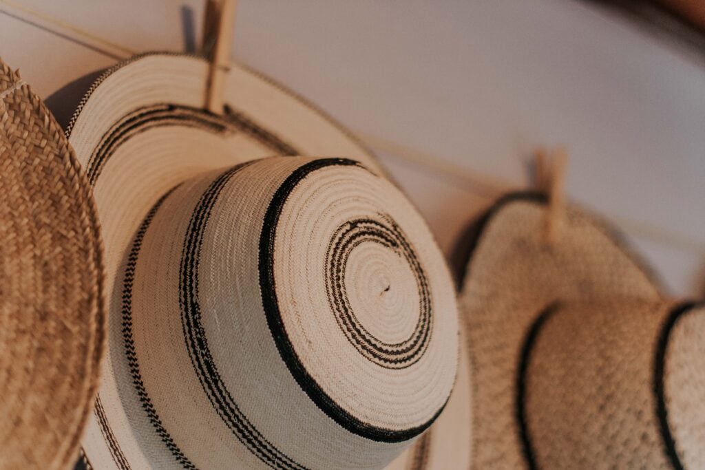 Closet organization tips - hang up your hats! Photo of hats hanging on wall.