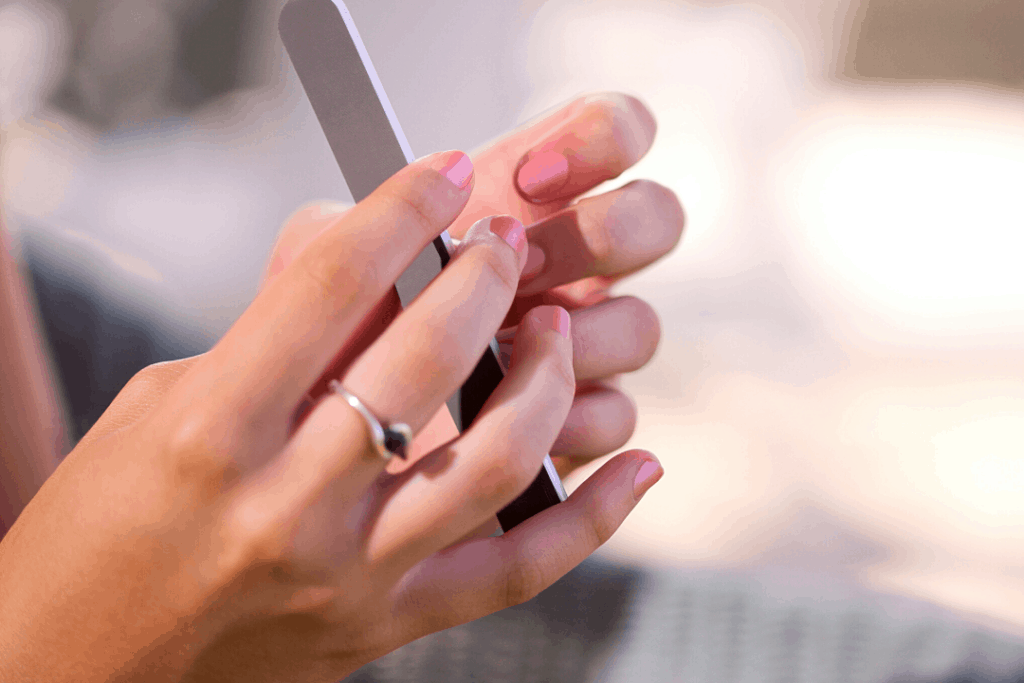 Woman filing her nails