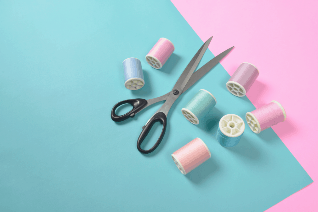 how to alter clothes - Photo of a sewing kit on a pink and blue background