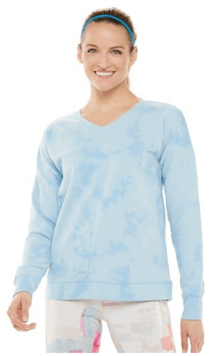 Model wearing Women's Tek Gear® Tie-Dye French Terry Sweatshirt in Pale Blue, skinny blue headband, and printed leggings, standing against white background