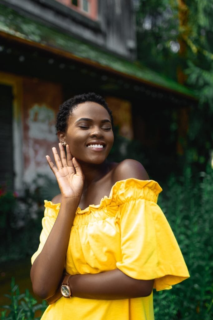 Jewelry trends 2020: Woman wearing yellow with earrings.