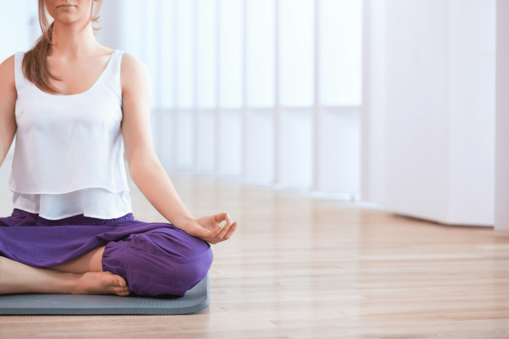 Woman doing yoga on a blue mat