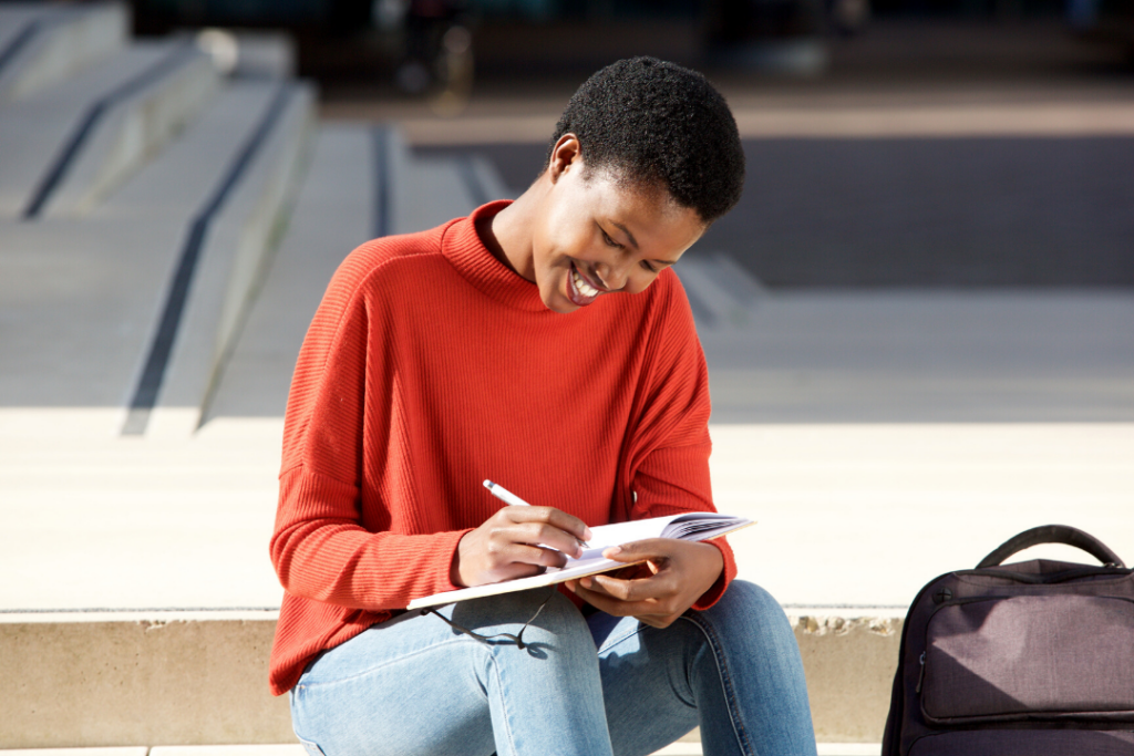 Black woman writing her plans