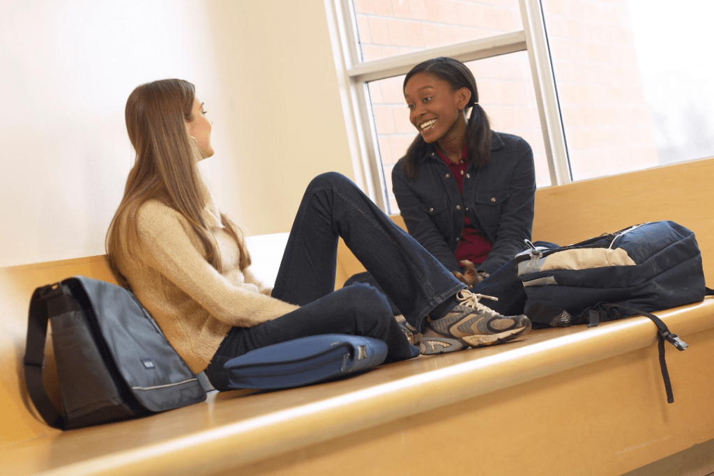 Two women talking in college