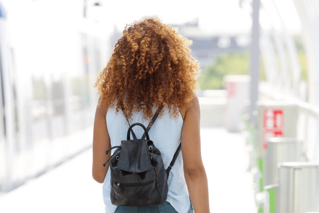 Photo of a woman walking away with her back turned