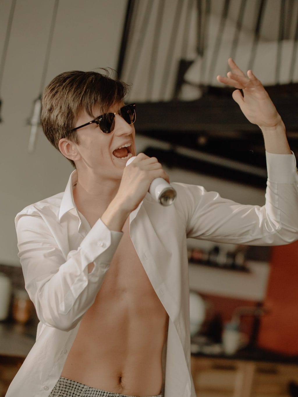 at home date ideasman in open shirt singing into can source: cottonbro from Pexels