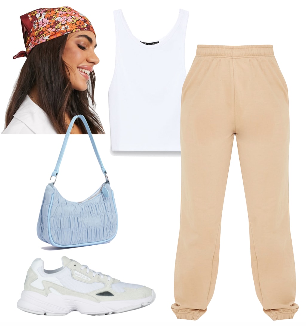 Kylie Jenner Outfit 2: beige jogger sweatpants, white crop tank top, multicolor floral print head scarf, blue ruched shoulder bag, and beige sneakers