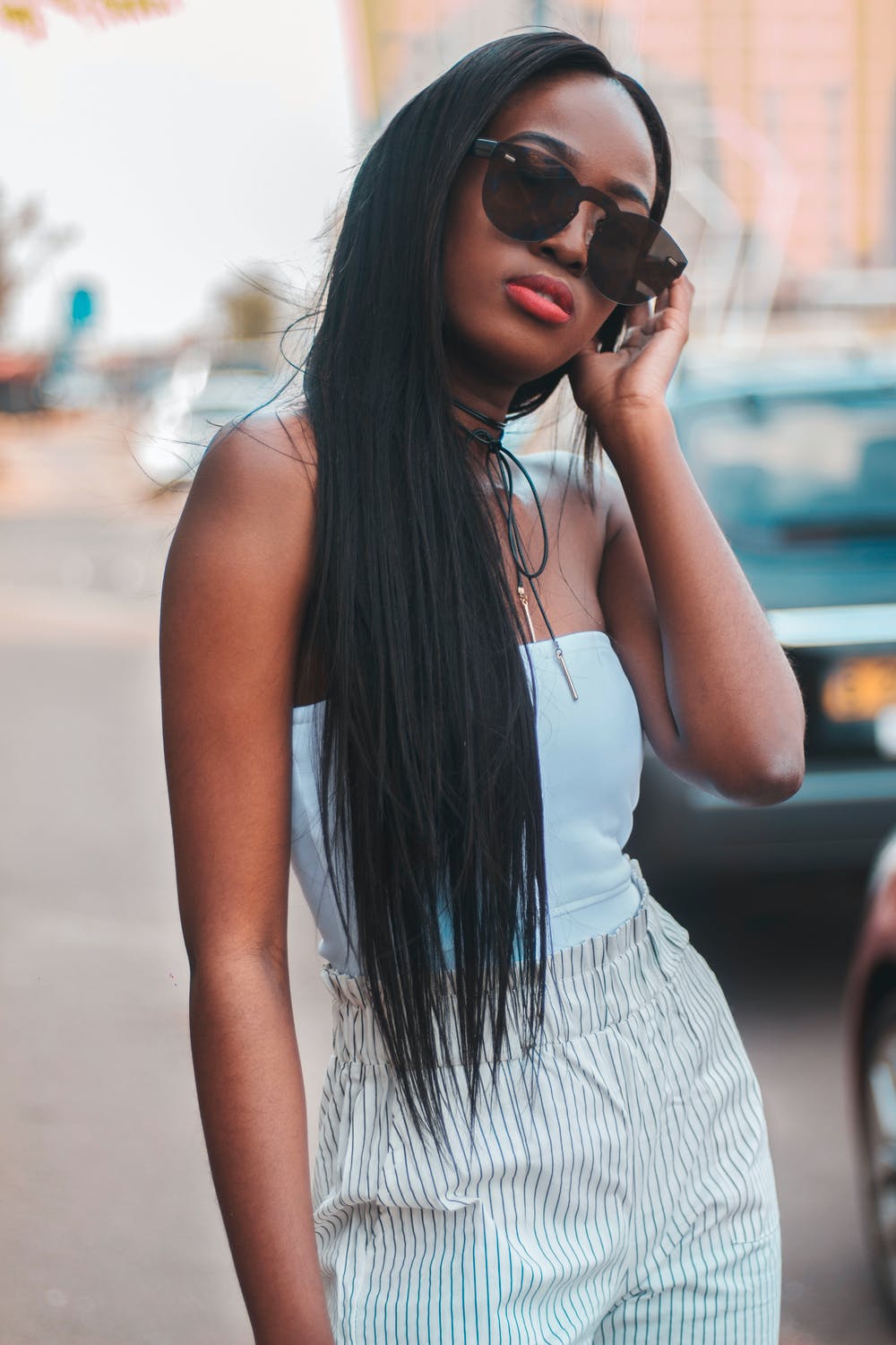 woman in sunglasses and a tube top posing, how to find your style