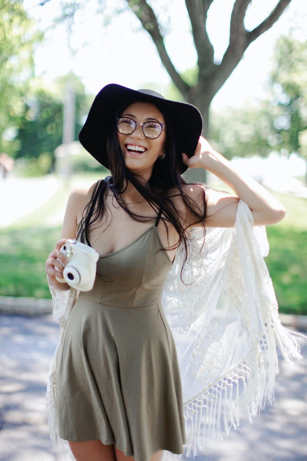 girl laughing and posing with polaroid, @leah-kelley-50725 from Pexels