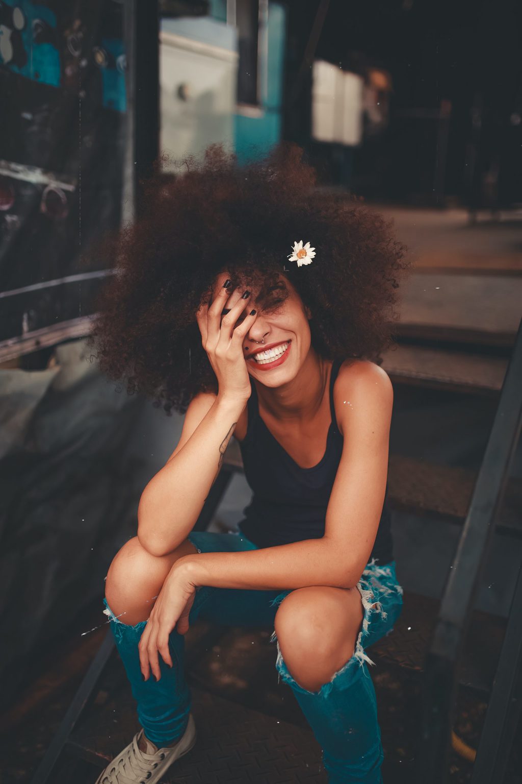 woman smiling with flower in hair happy