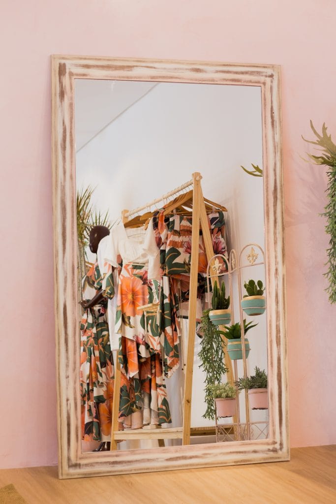 mirror reflecting room with clothes rack