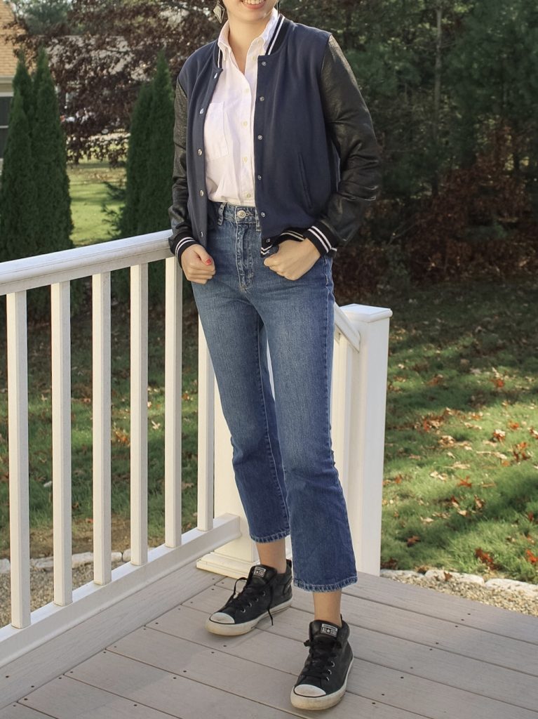 Photo of the author's outfit with jeans and a varsity jacket