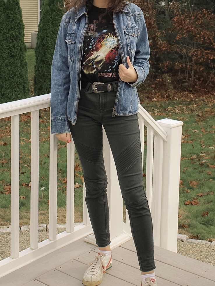 Photo of the author's outfit with a jean jacket, graphic tee, and biker pants