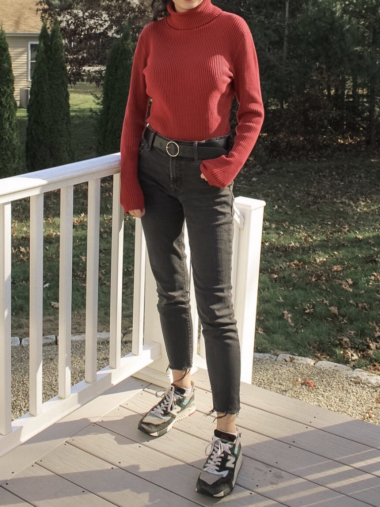 Photo of the author's outfit with a red turtleneck and black jeans