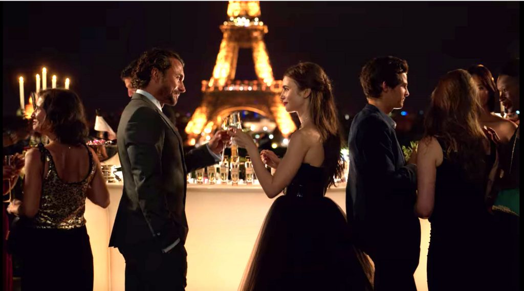 Emily in Paris outfits - photo of emily in front of the Eiffel tower in a black tulle strapless dress