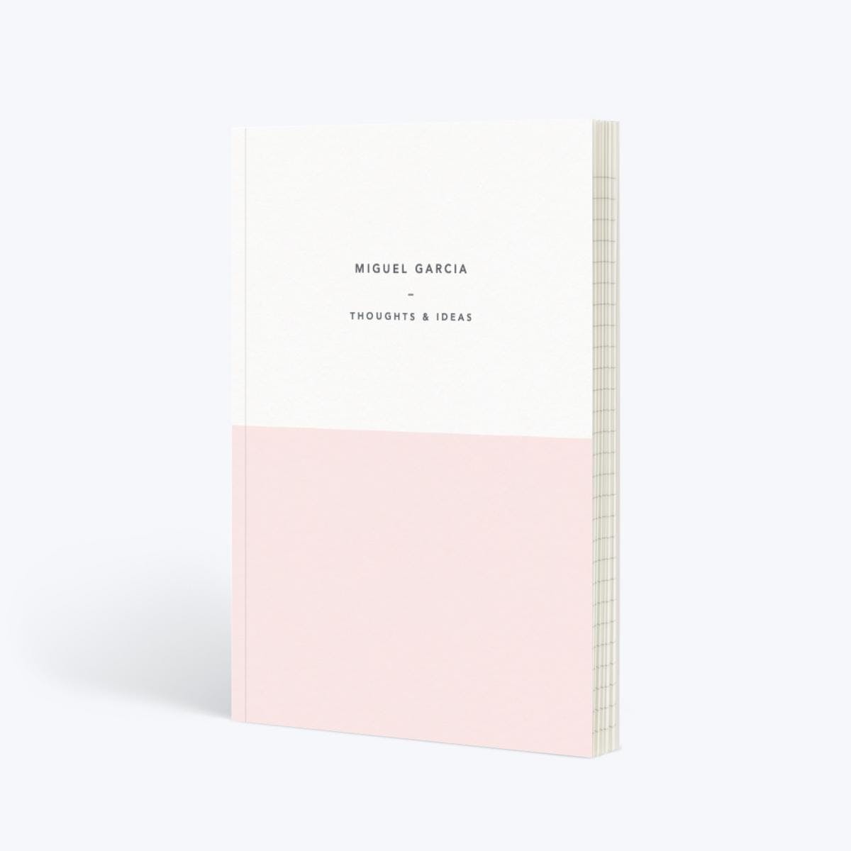 white and light pink colored journal