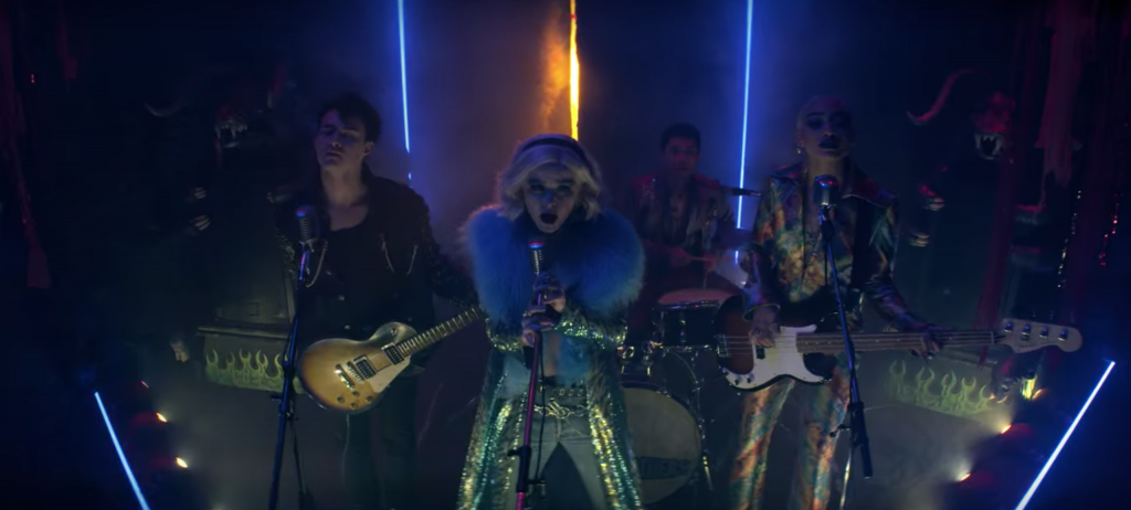 Screenshot from episode 16of The Chilling Adventures of Sabrina Spellman, Season 4 - Sabrina performing in a music venue in fur and sequin pants