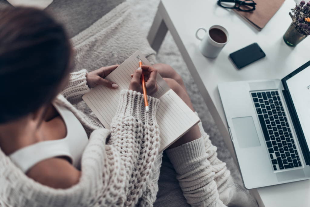 Woman writing down her goals