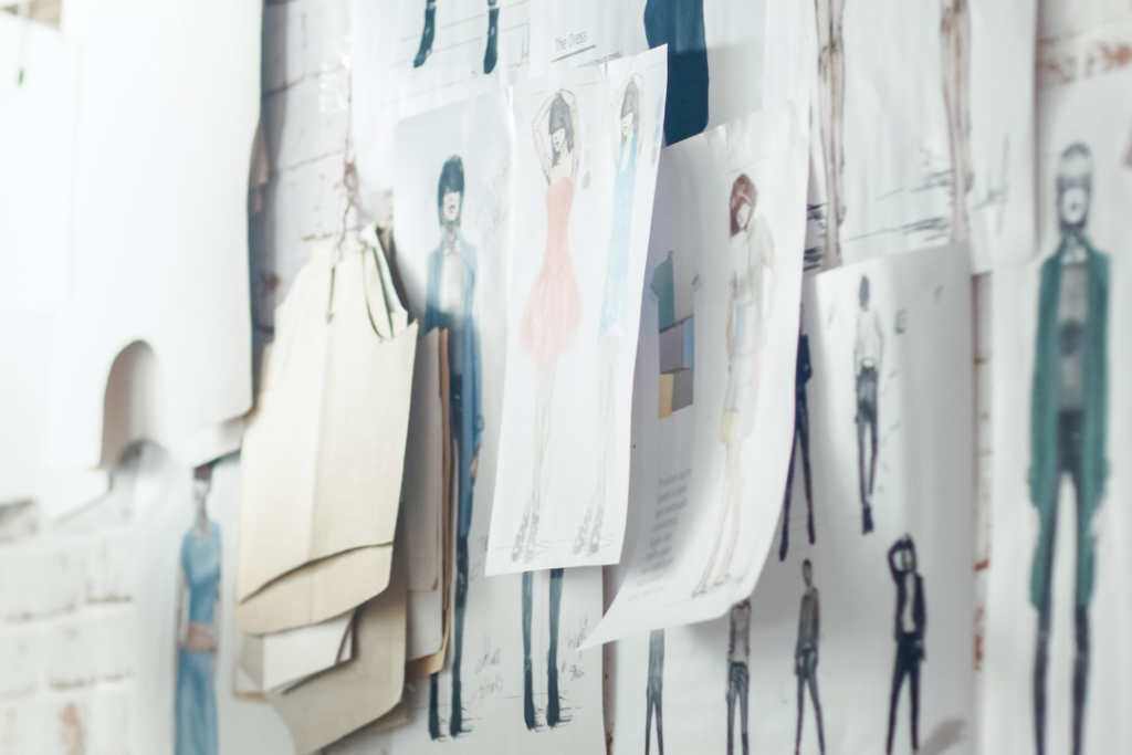 Fashion sketches pinned to a wall